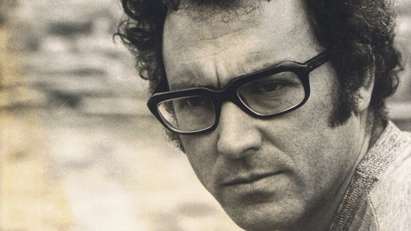 man with glasses looking down