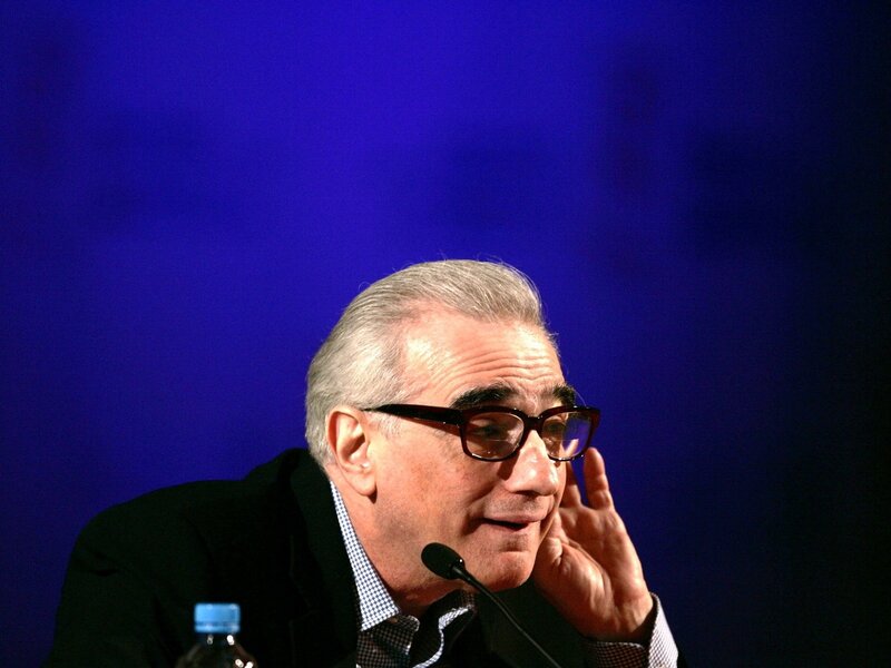 Man with Glasses Speaking — Blue