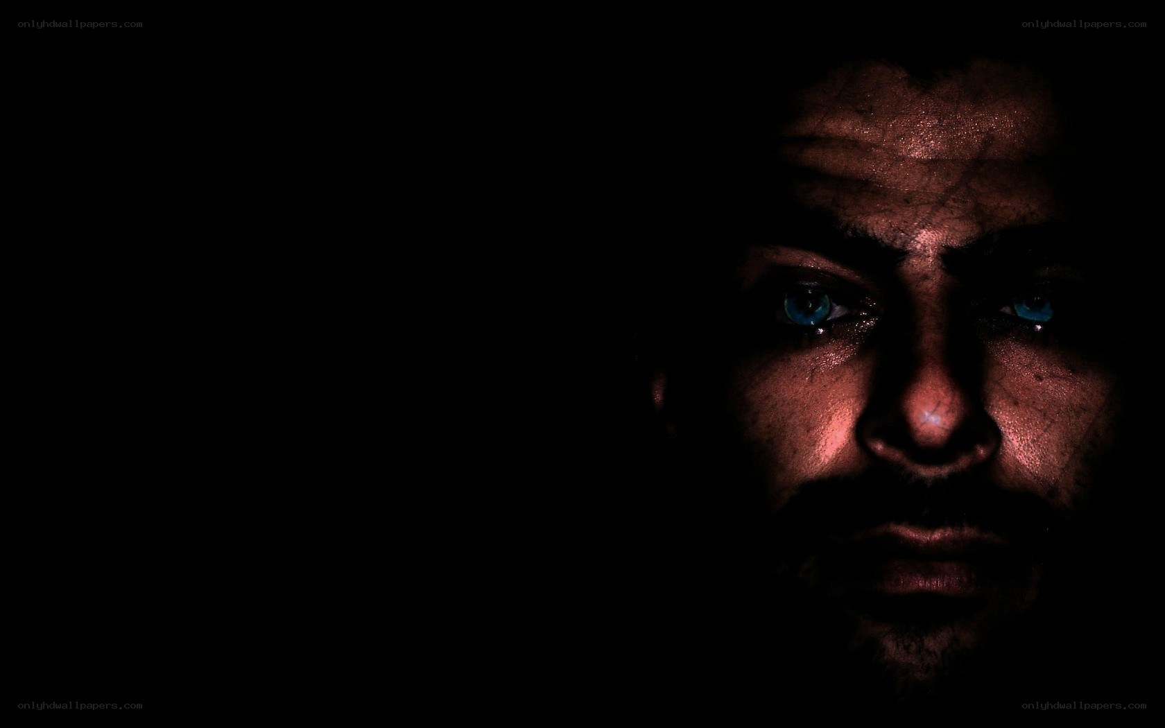 man with glowing eyes in darkness