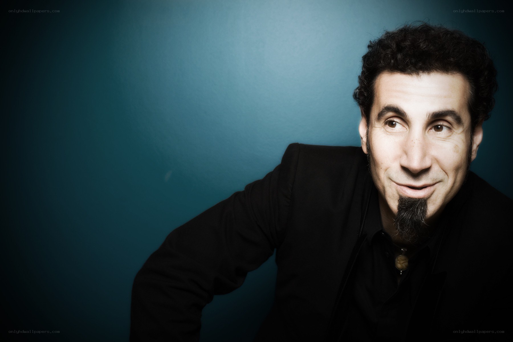 man with goatee in black suit