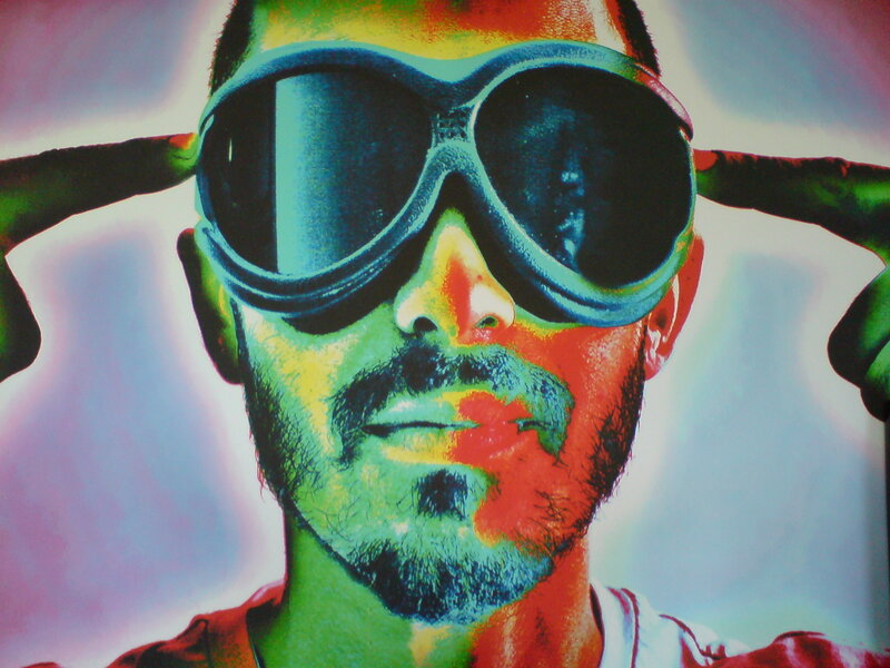 man with goggles and colorful face