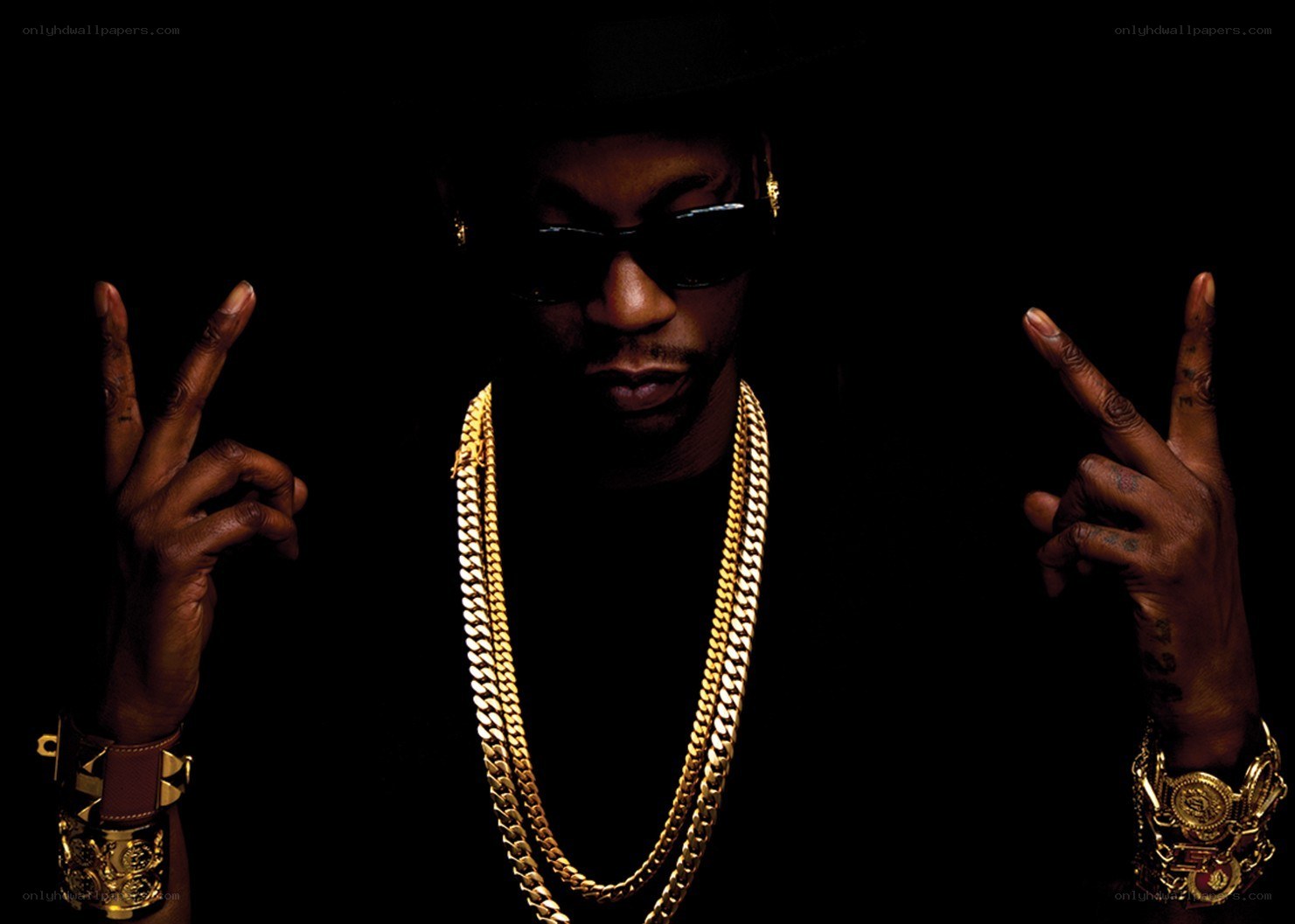 man with gold chains and sunglasses