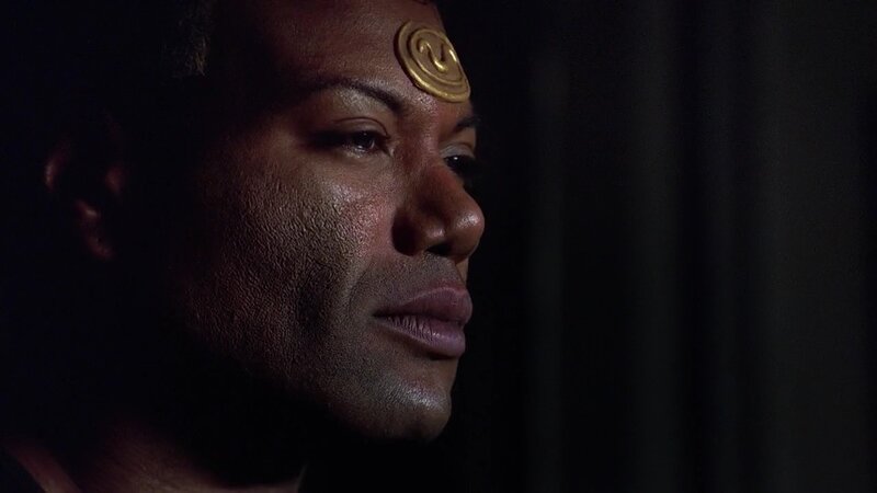 man with golden symbol on forehead