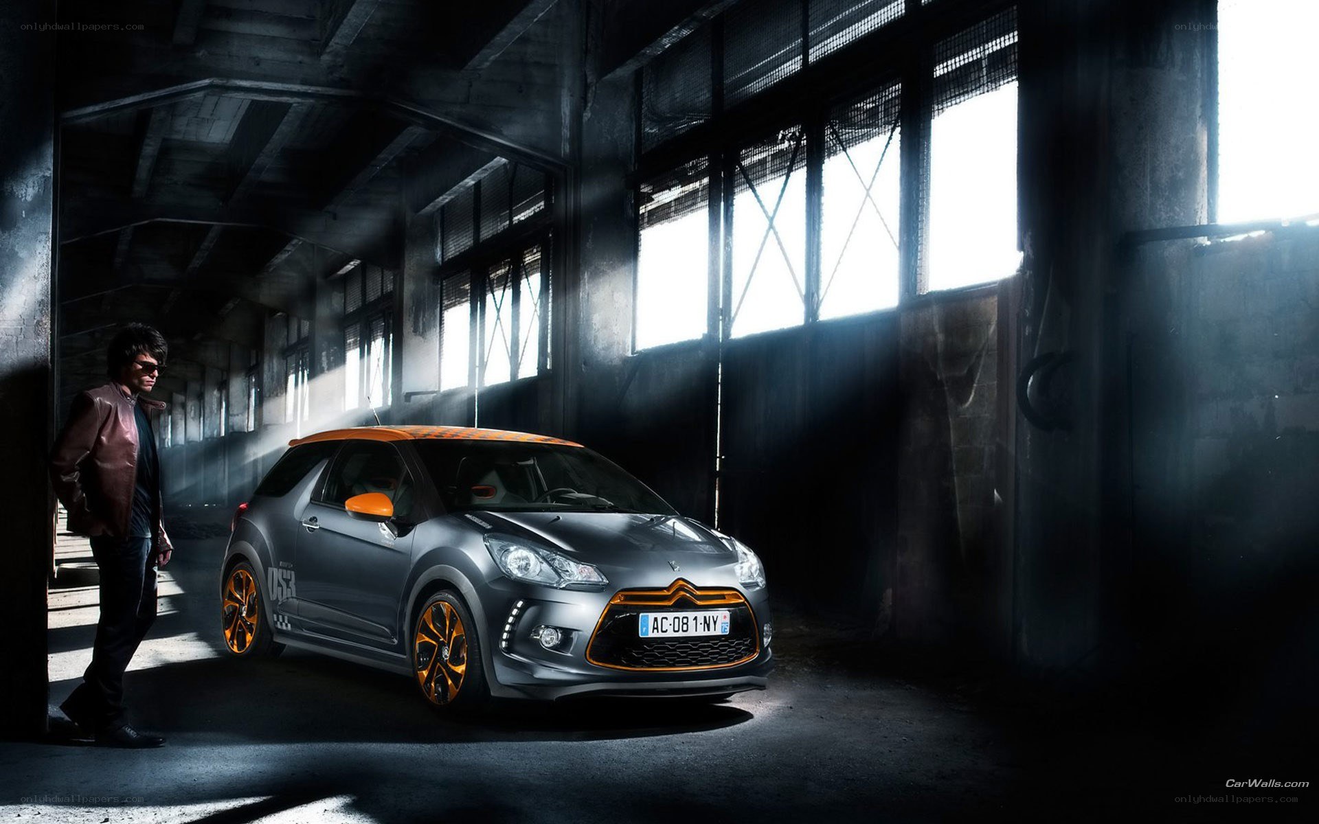 Man with gray car in warehouse