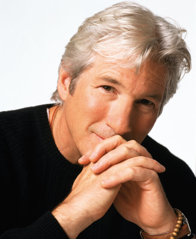 man with gray hair in black sweater
