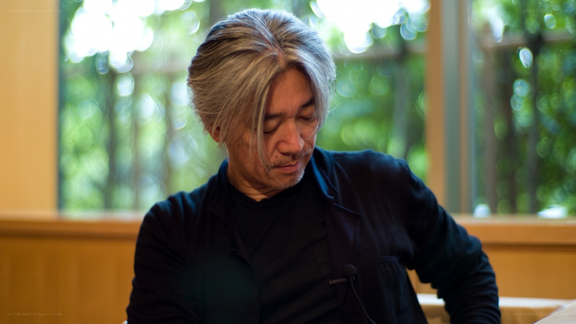 man with gray hair looking down