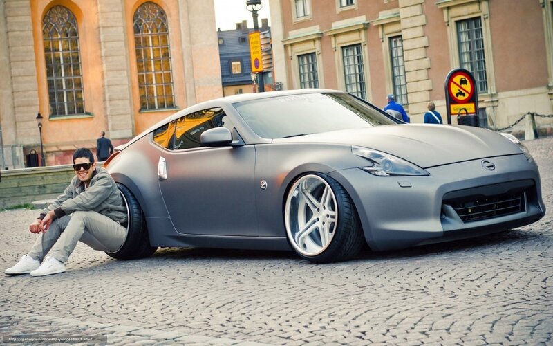 Man with gray sports car