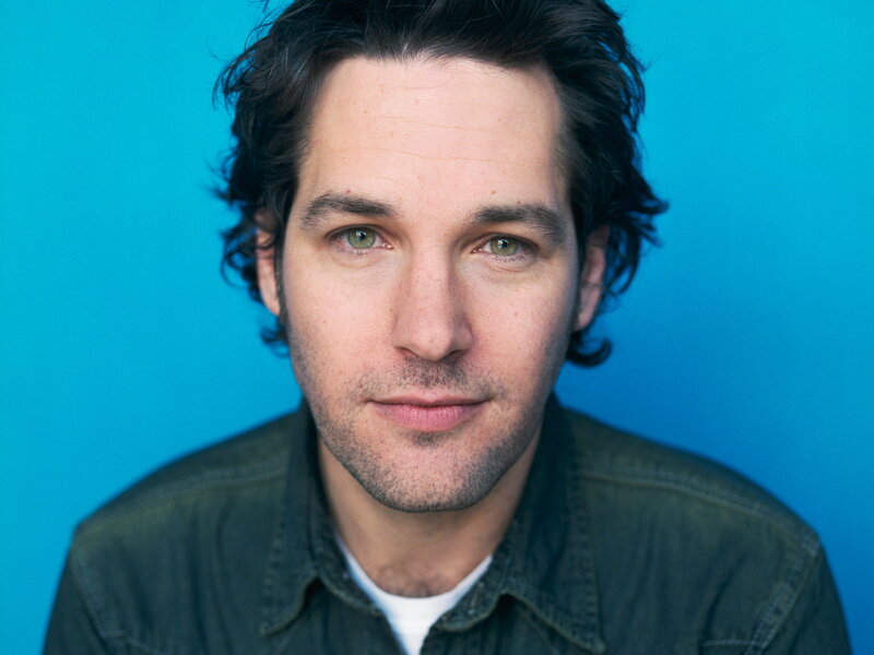 man with green eyes against blue background