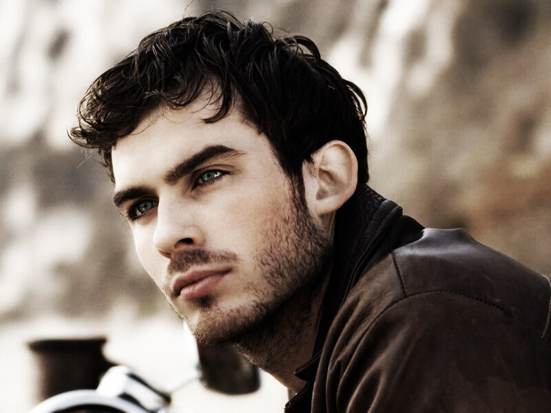 man with green eyes in leather jacket
