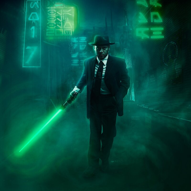 Man with green lightsaber in alley