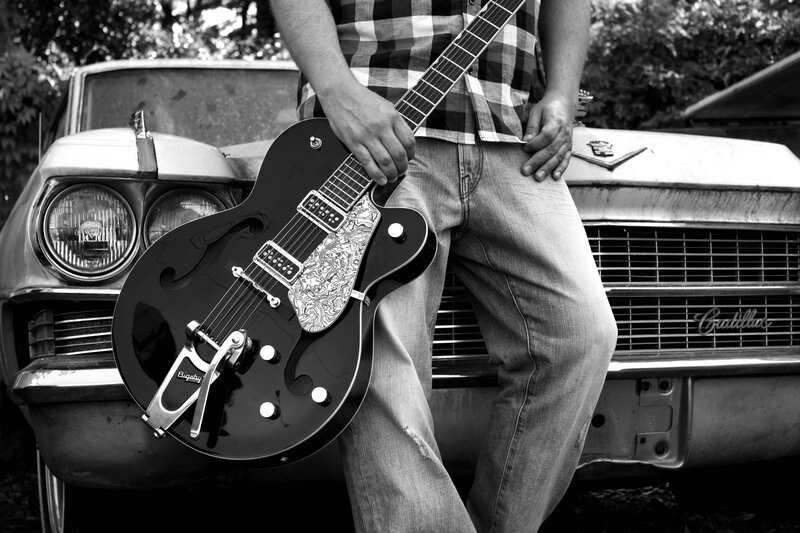 man with guitar and classic car