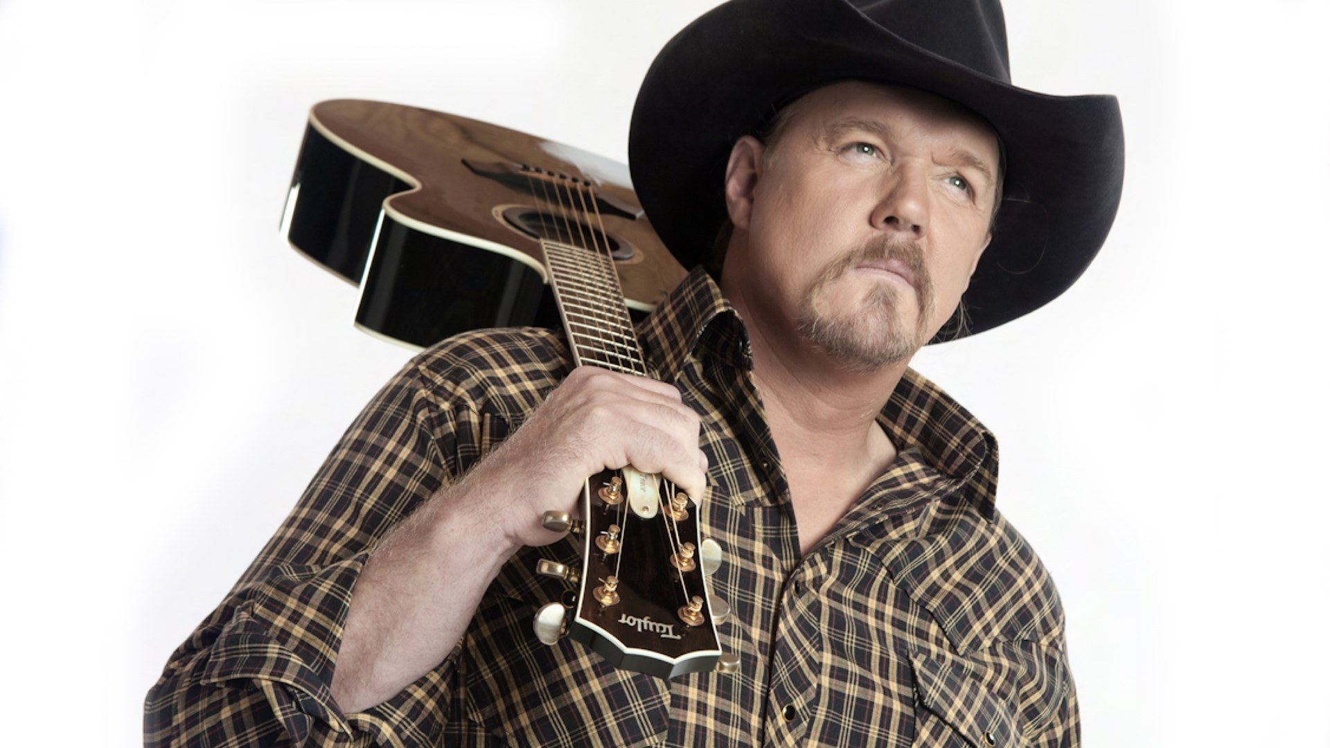 man with guitar and cowboy hat