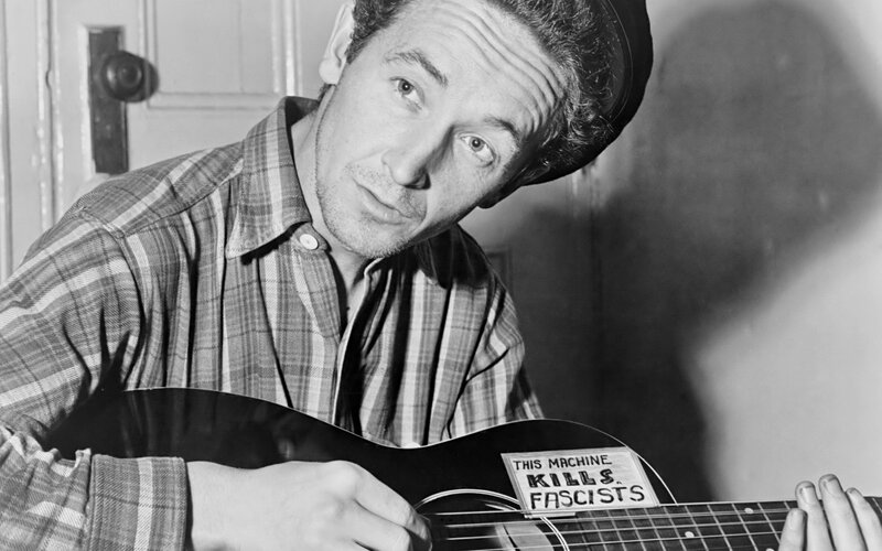 Man with guitar and political sign