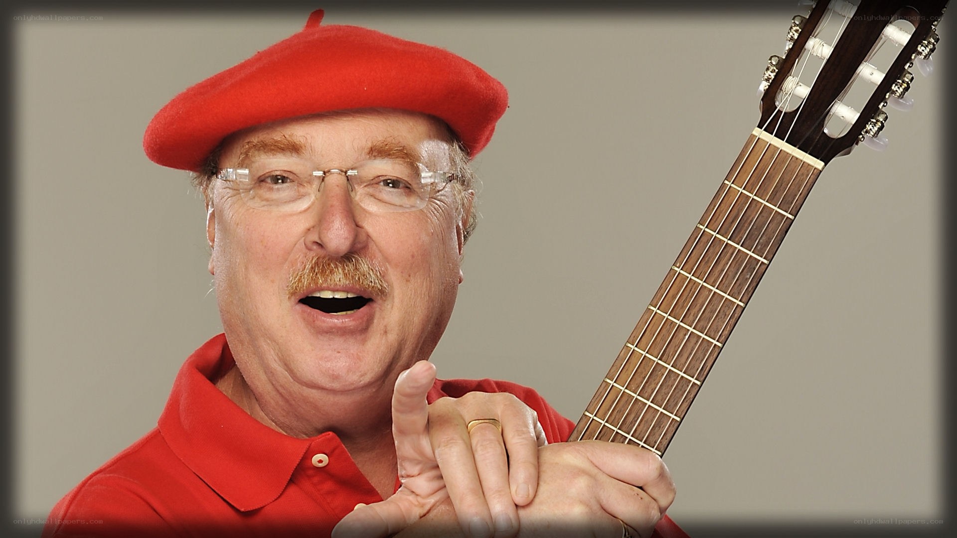 man with guitar and red hat