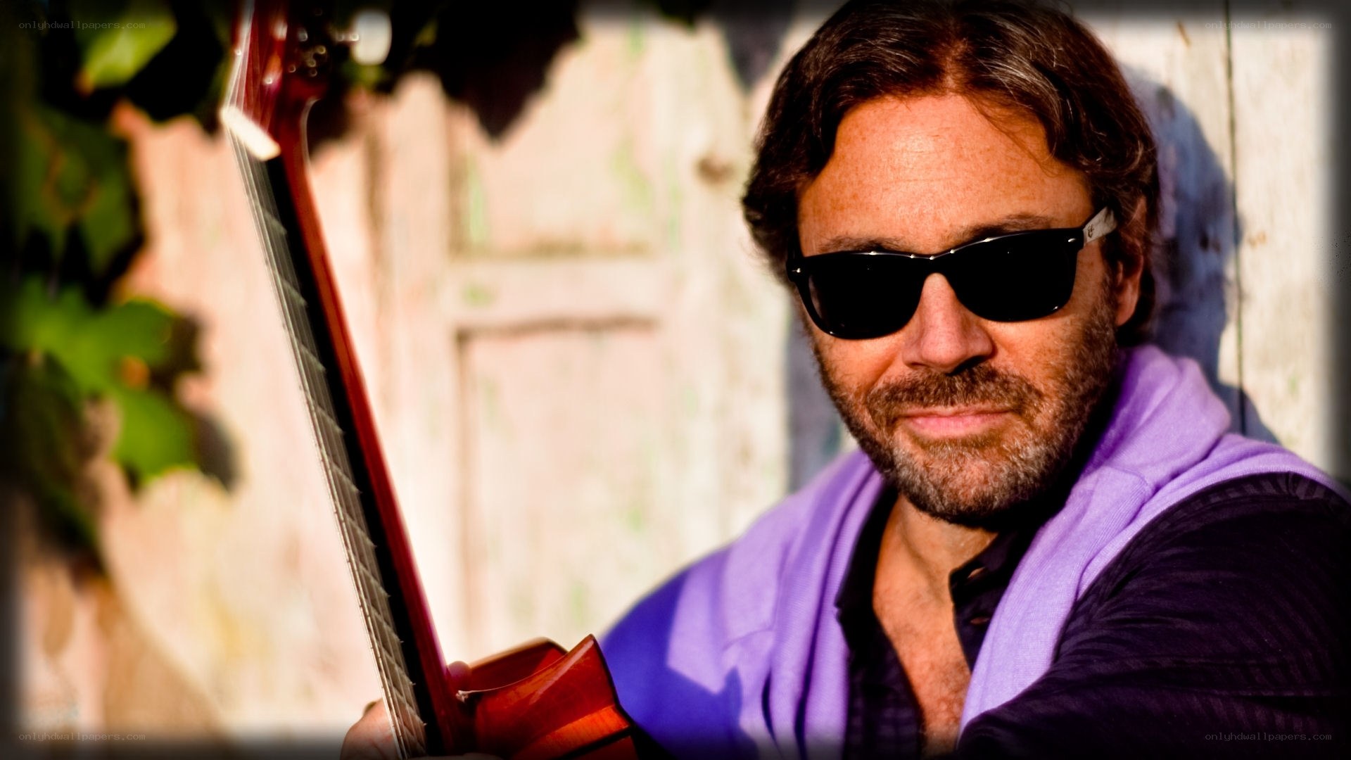 man with guitar and sunglasses