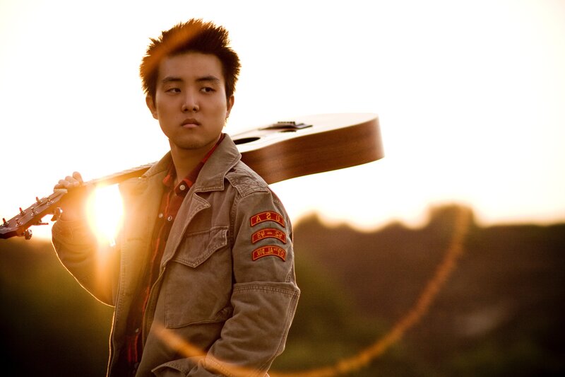 man with guitar at sunset