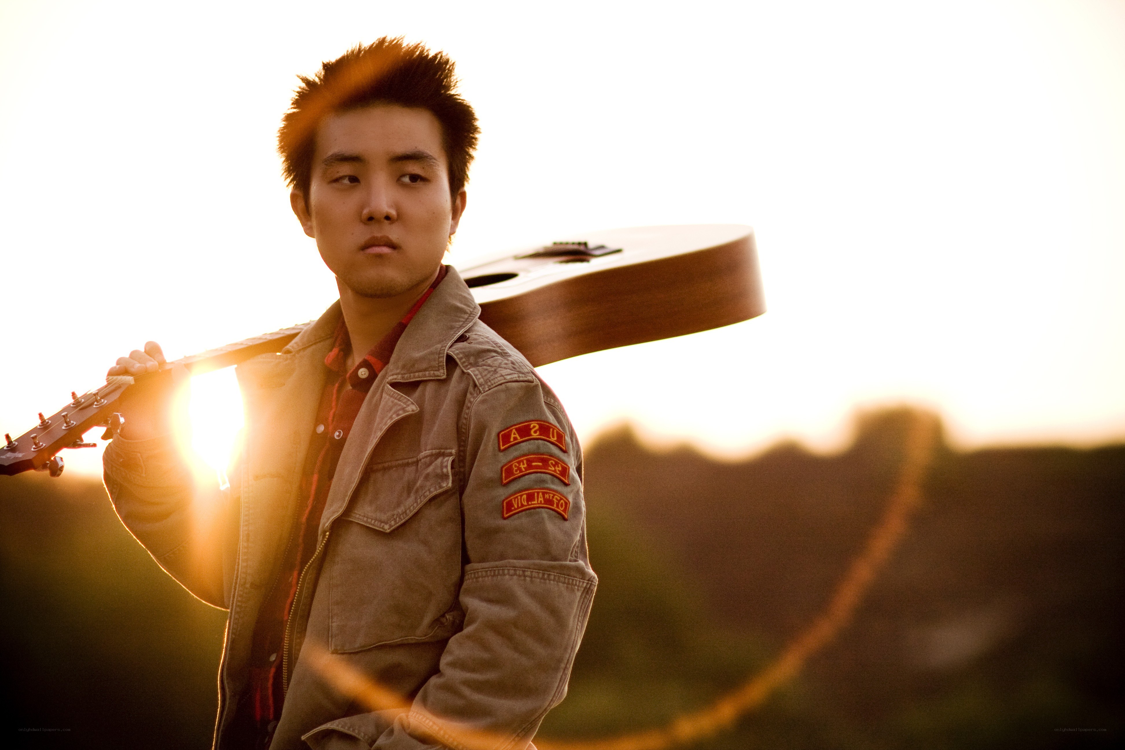 man with guitar at sunset