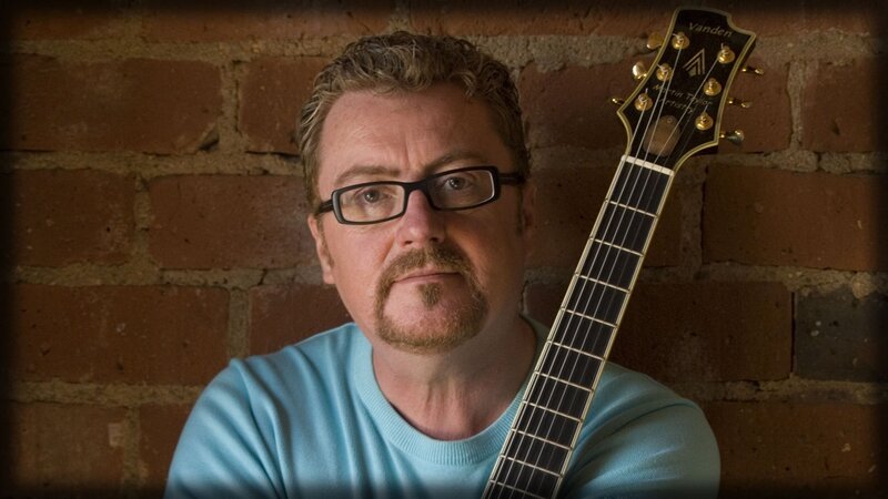 Man with Guitar — Brown, Serious