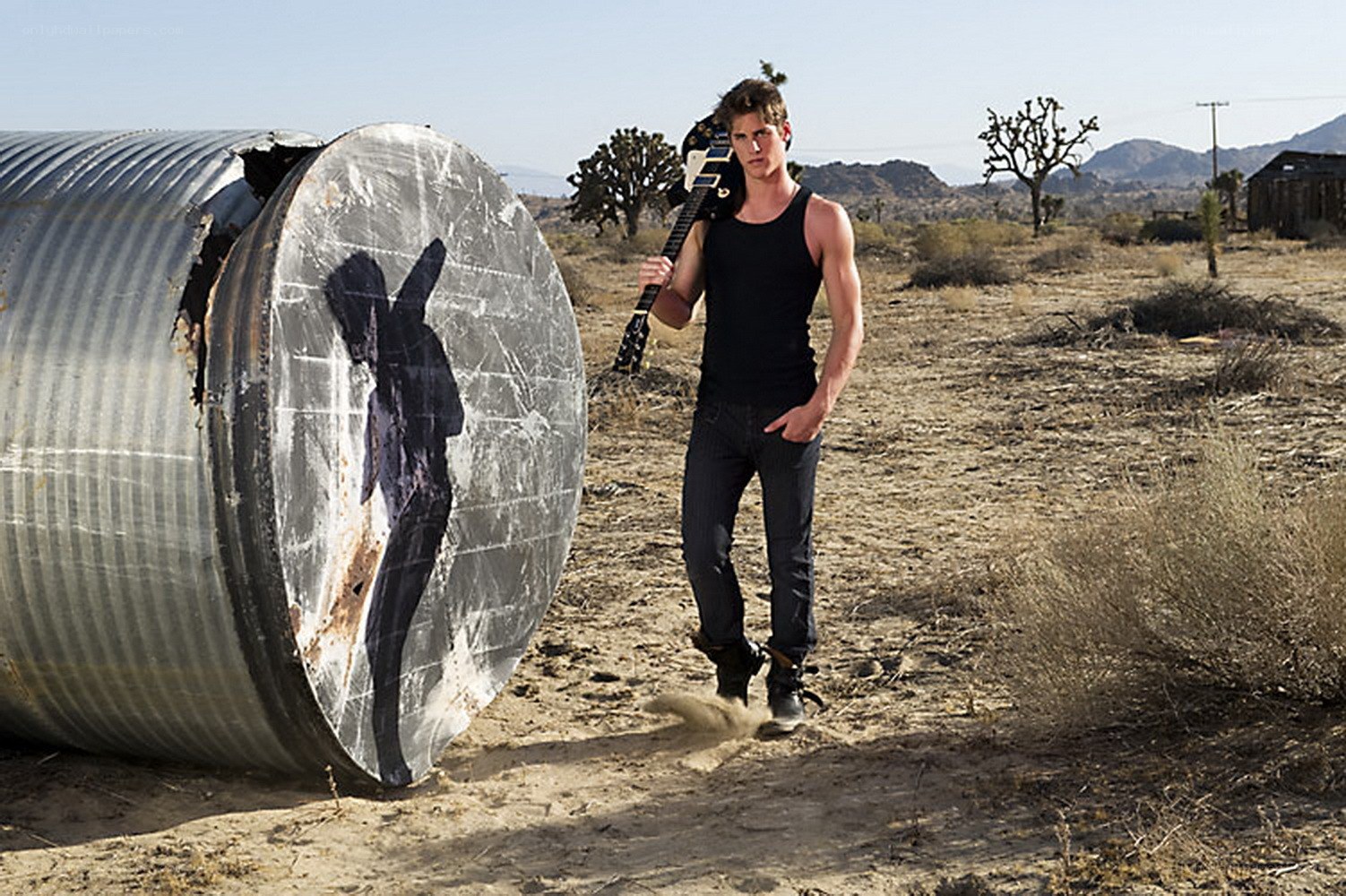 man with guitar in desert