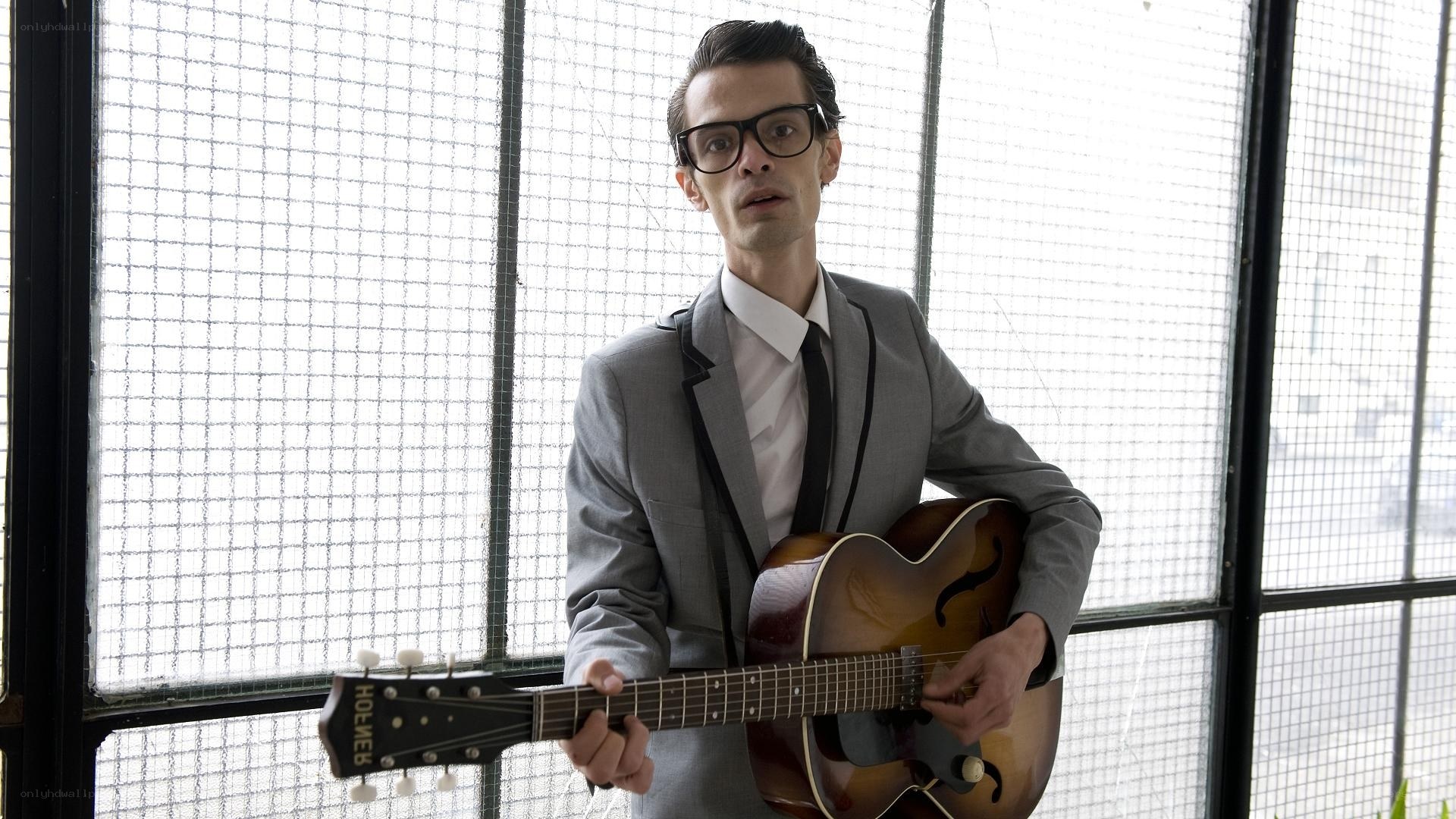 Man with guitar in suit