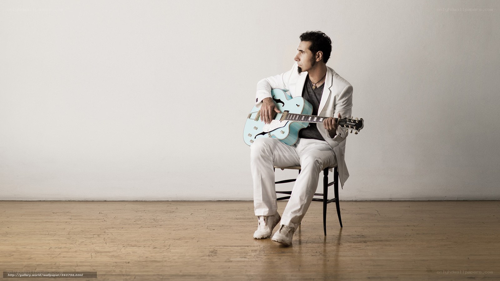 man with guitar in white suit