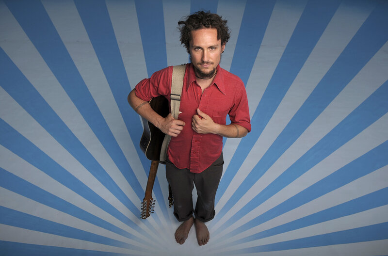 man with guitar on blue background