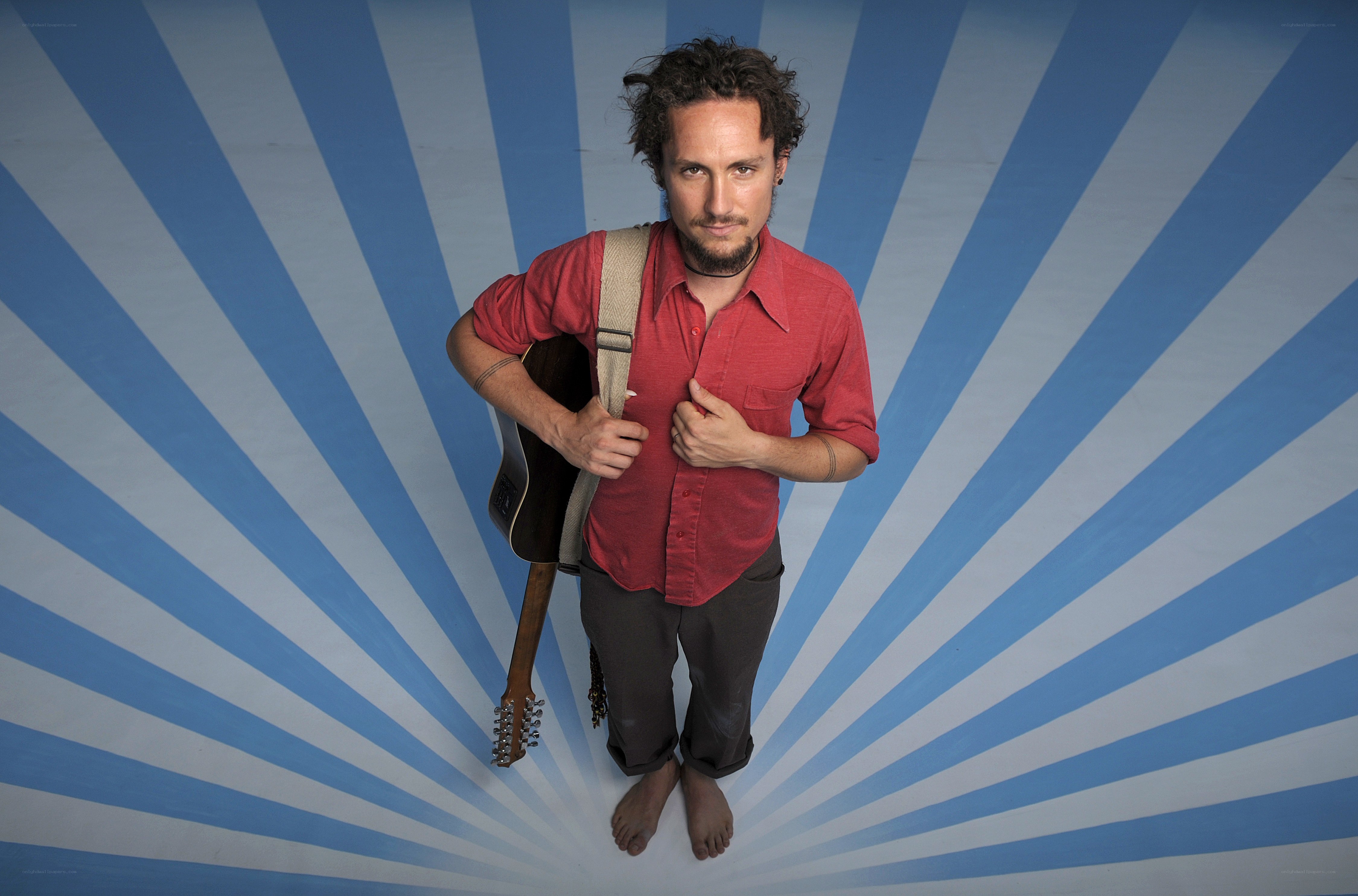 man with guitar on blue background