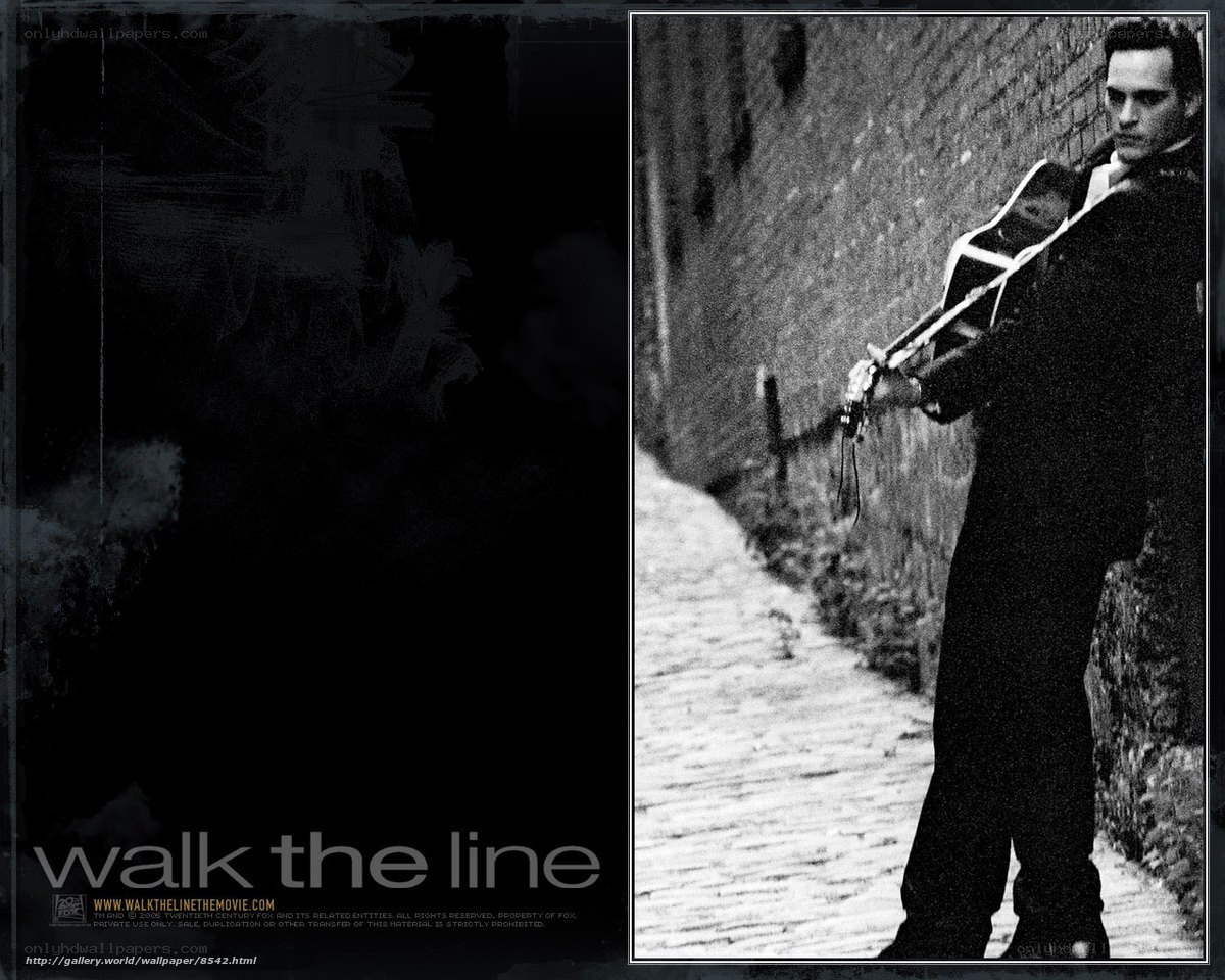 man with guitar on cobblestone path