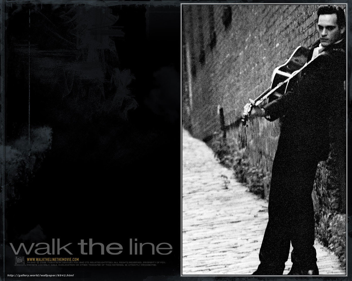 man with guitar on cobblestone path