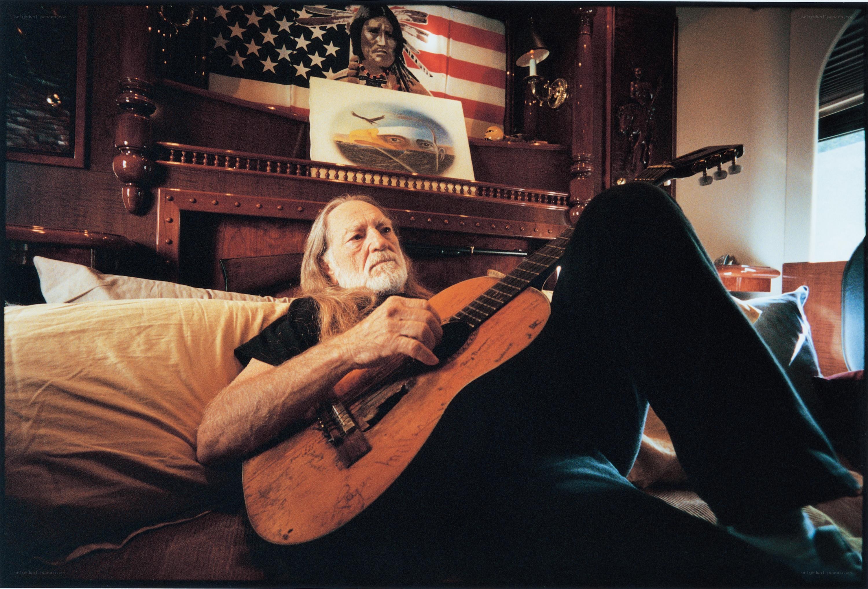 man with guitar on couch