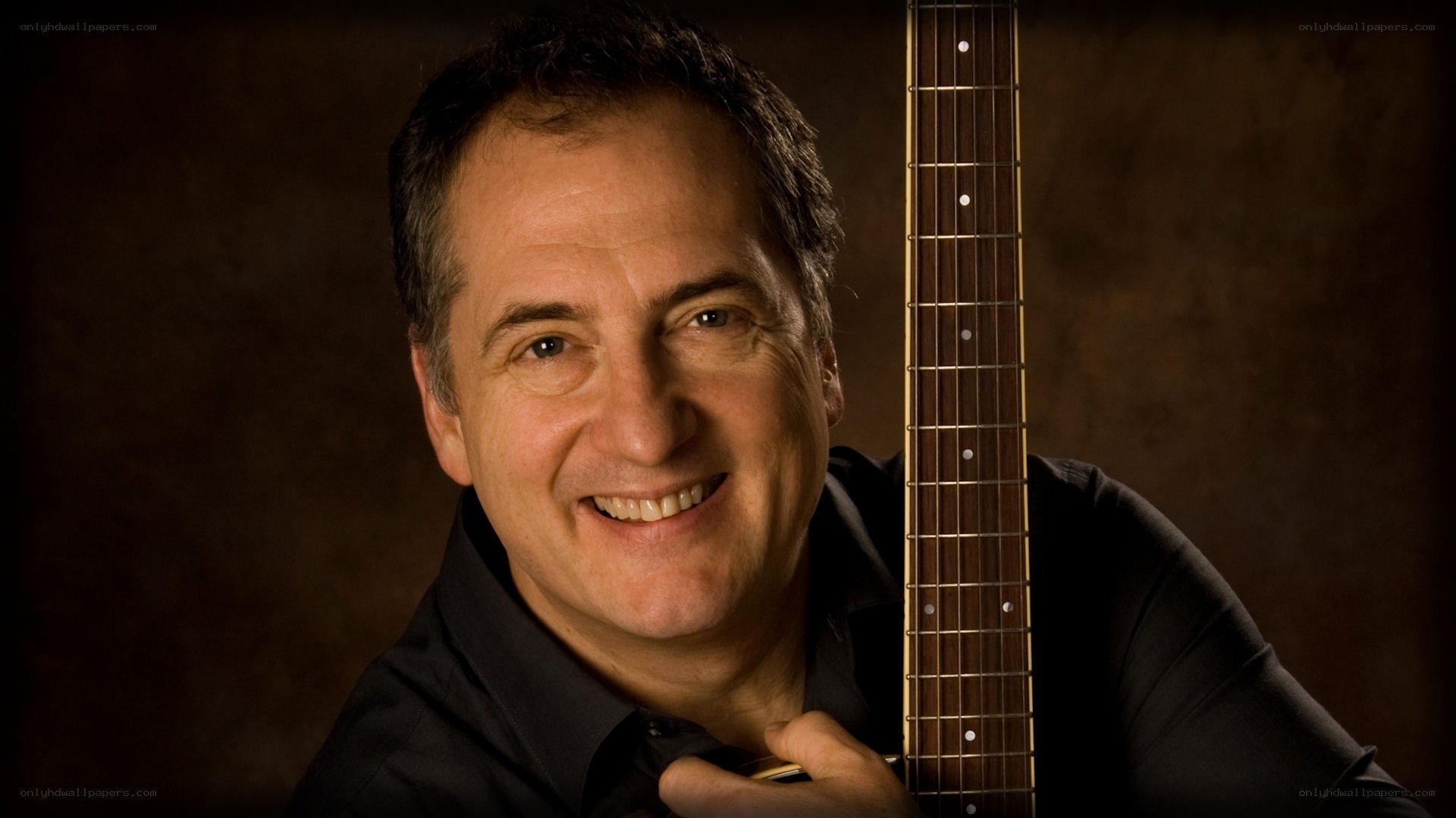 man with guitar smiling