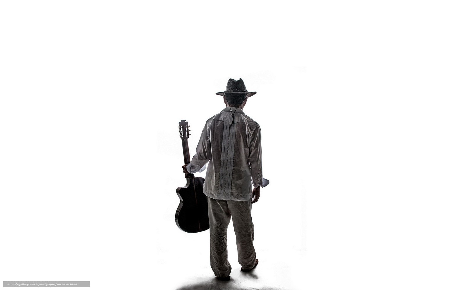 Man with guitar walking away
