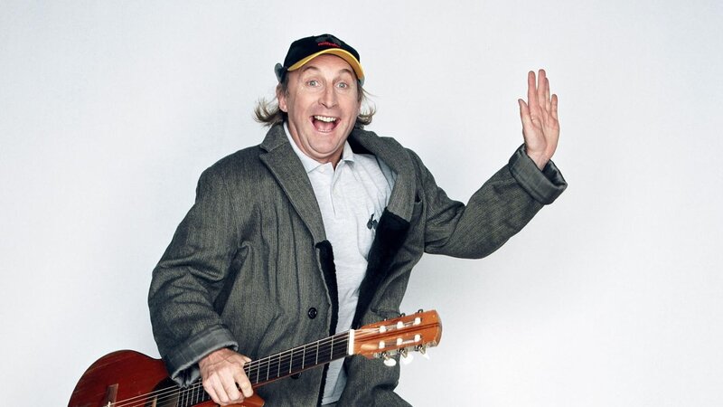 Man with guitar waving