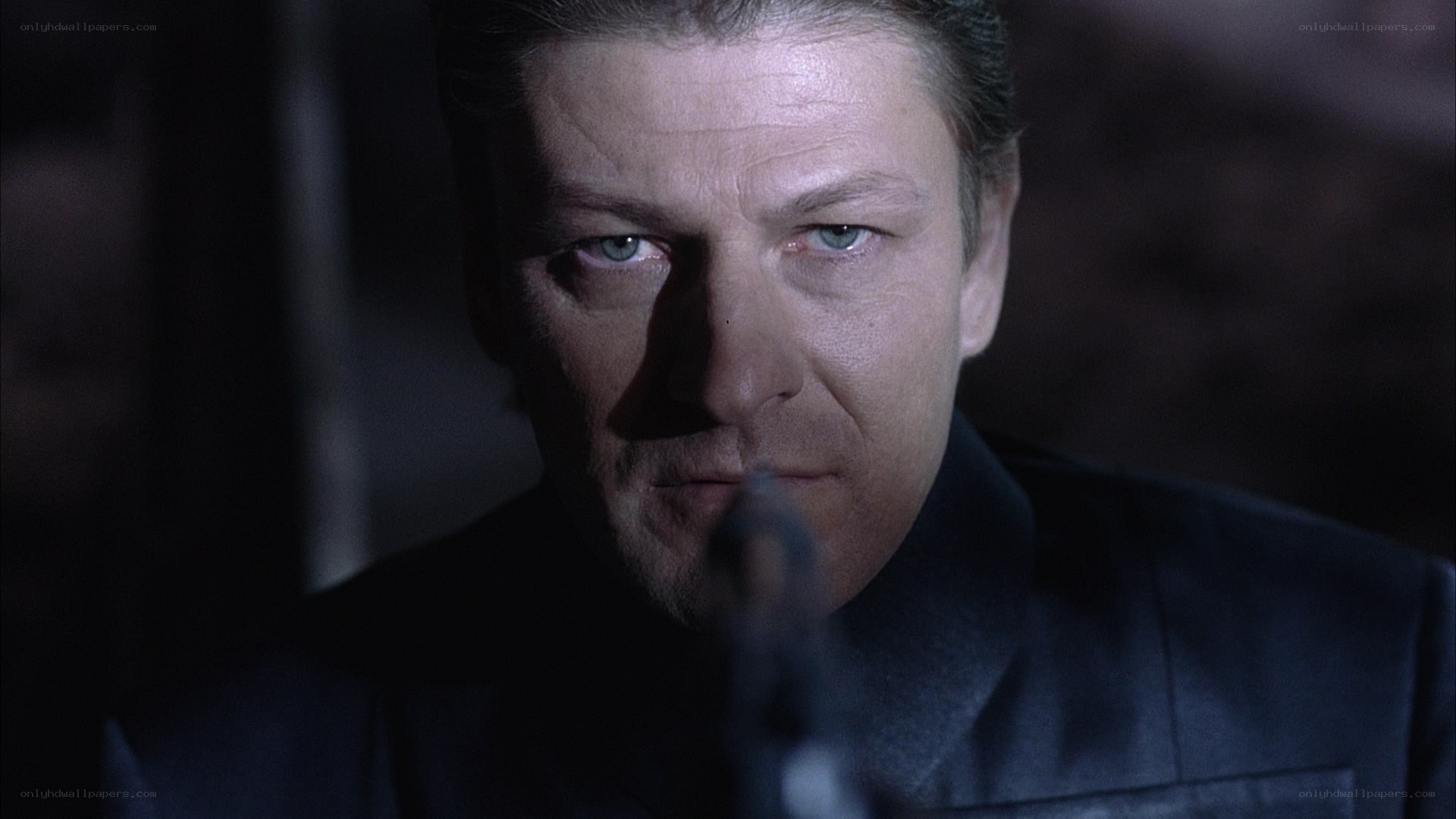 man with gun in dark room