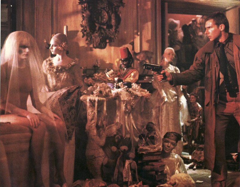 Man with gun in room of mannequins