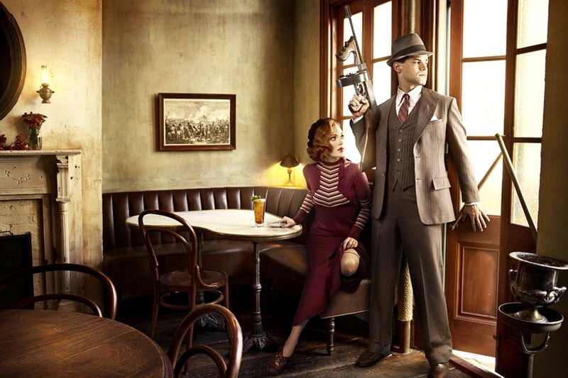 Man with gun in vintage cafe