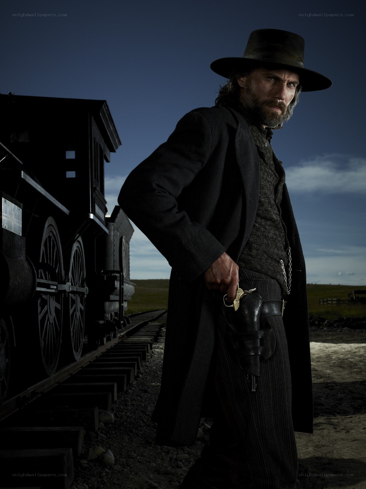 man with gun near train