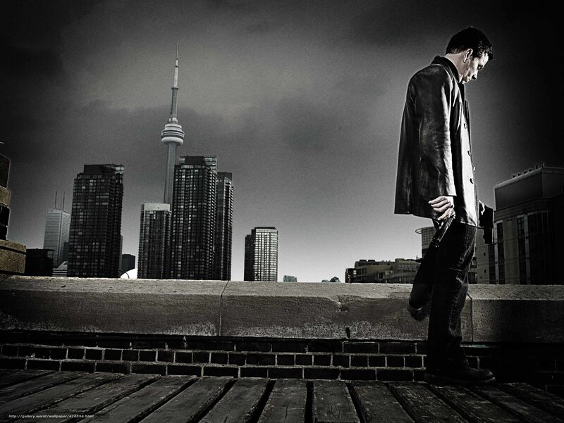 Man with gun on rooftop
