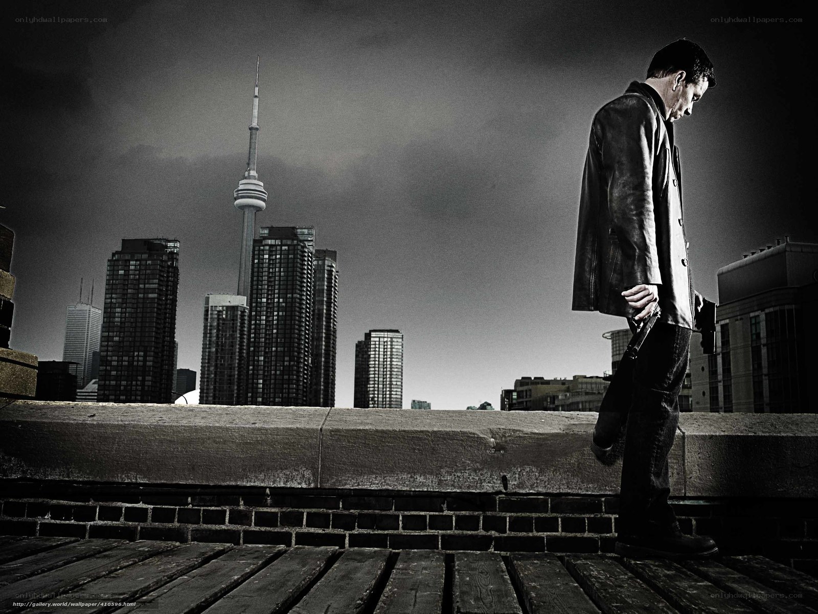 Man with gun on rooftop
