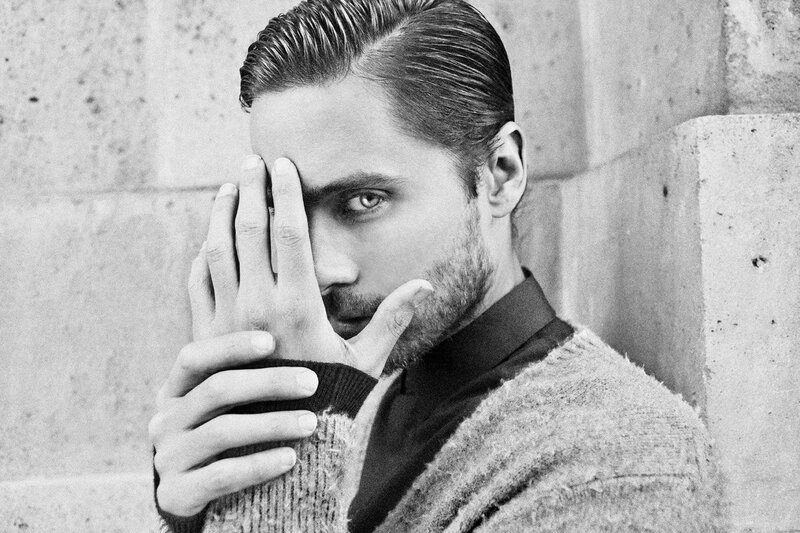 man with hand covering face
