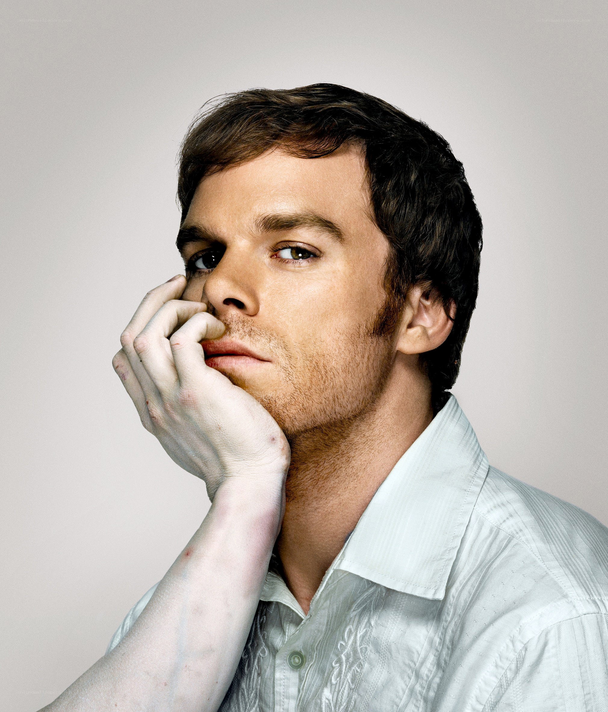 man with hand on face