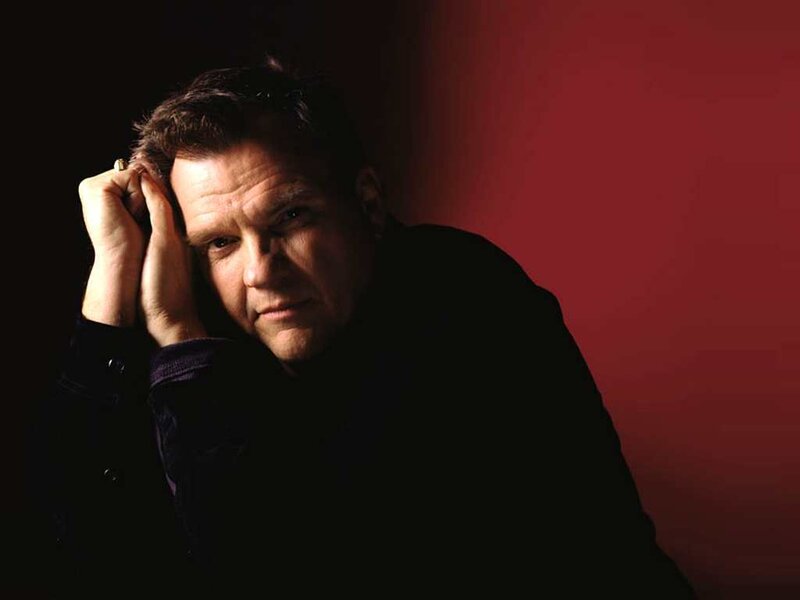 man with hand on head