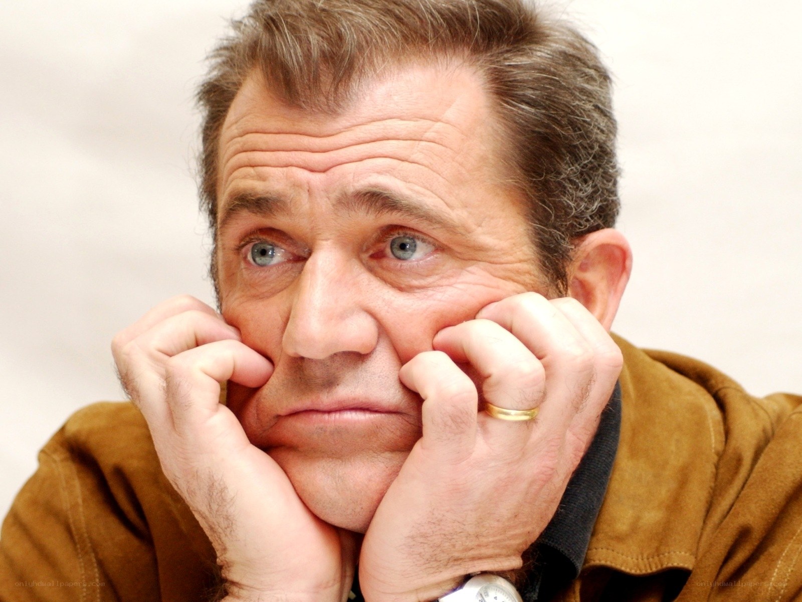 man with hands on face