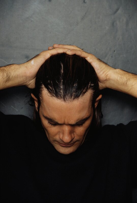 man with hands on head