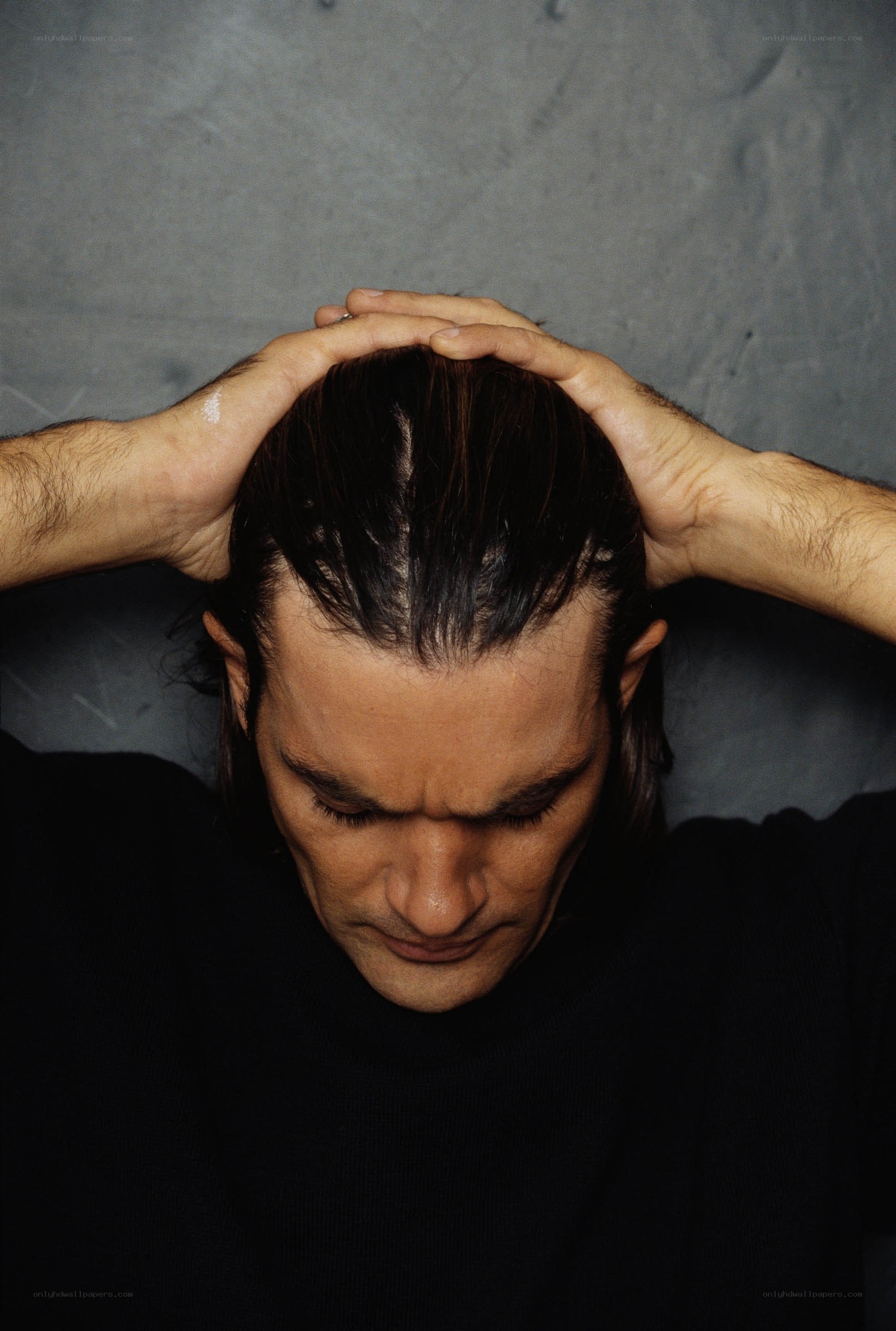 man with hands on head