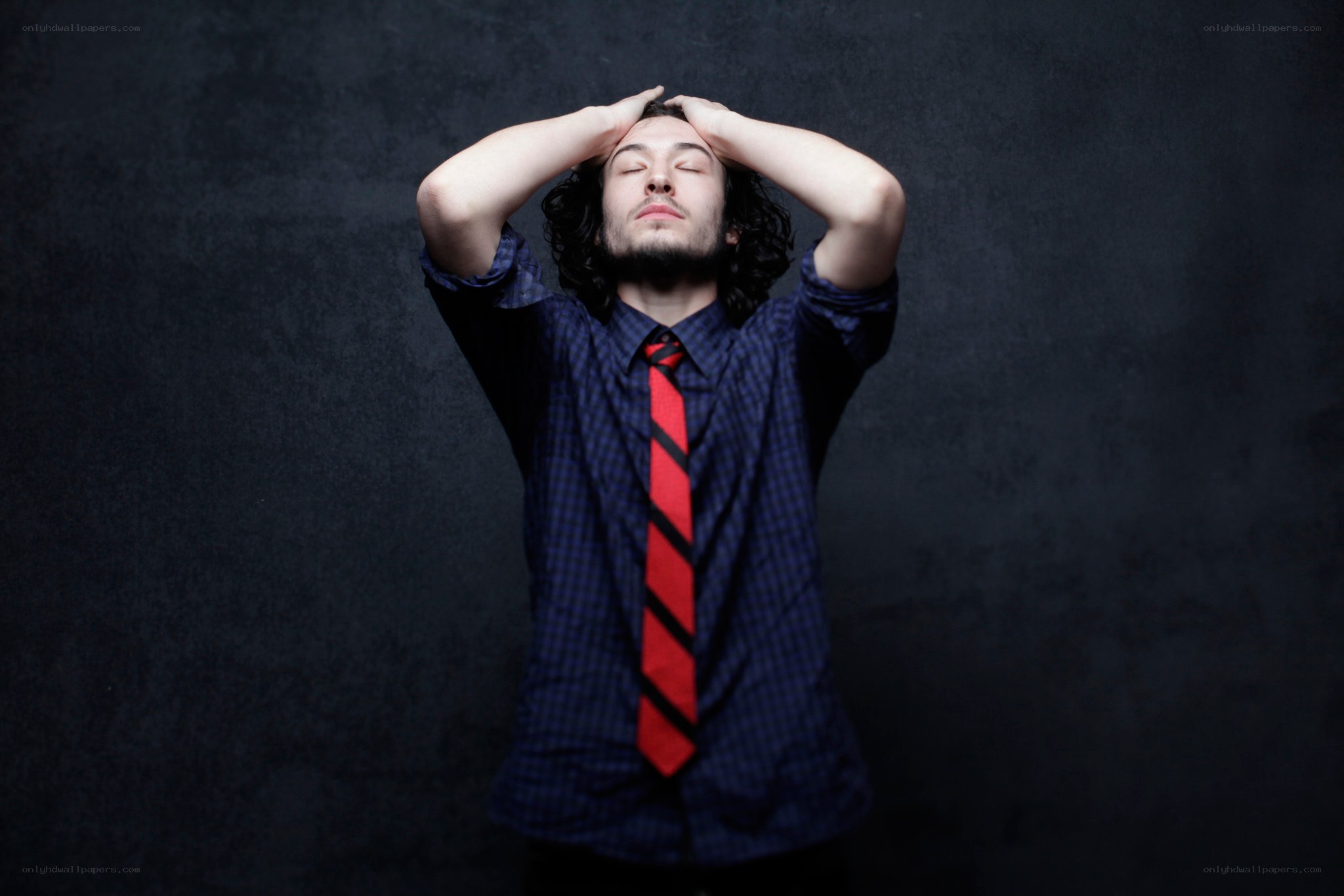 man with hands on head