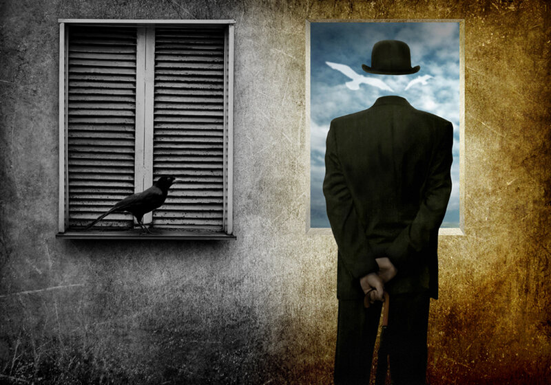 man with hat looking out window