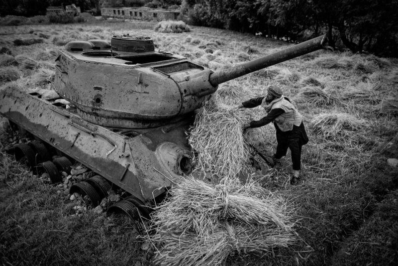 Man with Hay Near Tank