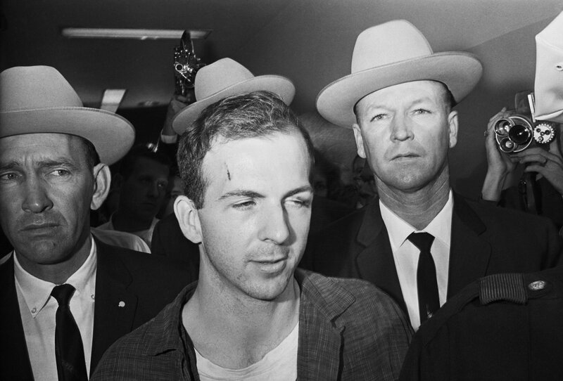Man with head injury surrounded by men