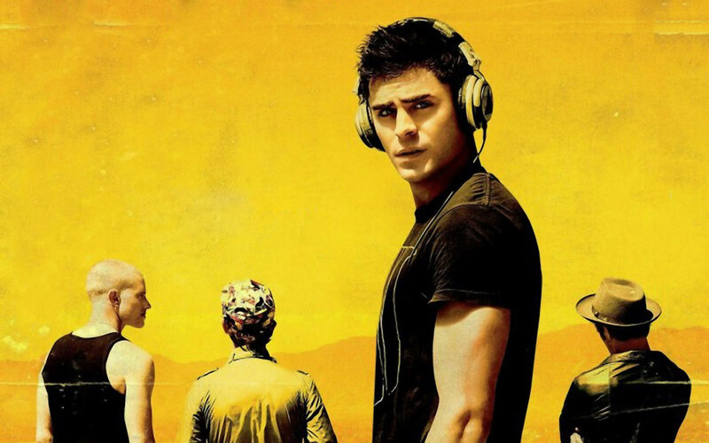 man with headphones in desert